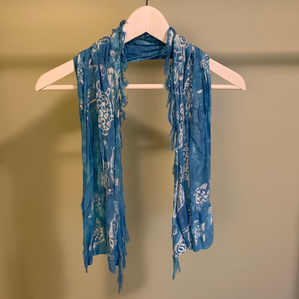 Blue and white sea turtle scarf with tassels.